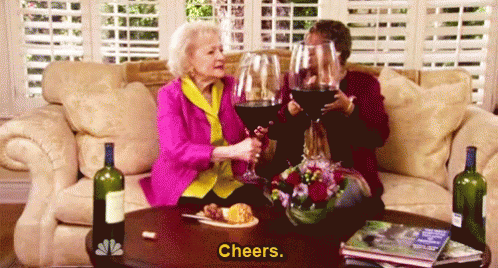 Betty White and Someone else clinking Giant Wine Glasses